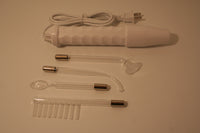 A picture of all the components of our solid state violet wand kit. This kit contains a solid state violet wand and four glass attachments of probes. 