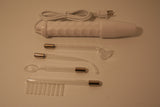 A picture of all the components of our solid state violet wand kit. This kit contains a solid state violet wand and four glass attachments of probes. 