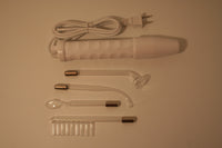 A picture of all the components of our solid state violet wand kit. This kit contains a solid state violet wand and four glass attachments of probes. 