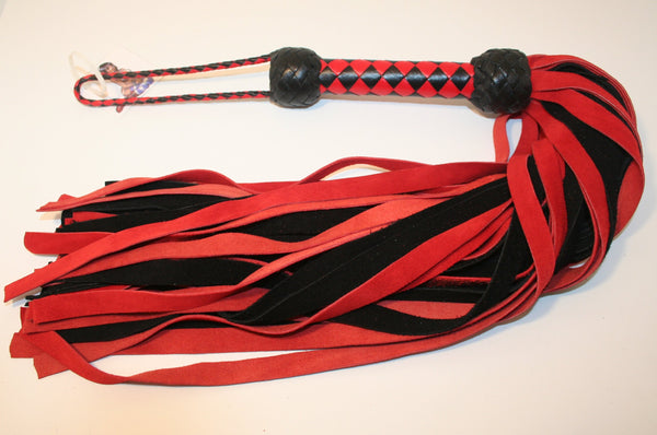 Leather Flogger made from red and black suede leather with a woven diamond pattern handle that has two black turks heads, one turks head on each end. 